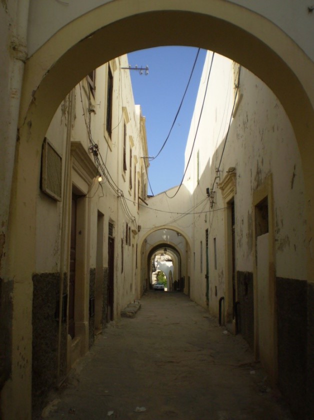 A narrow street running through a residential area in Tripoli, Libya.